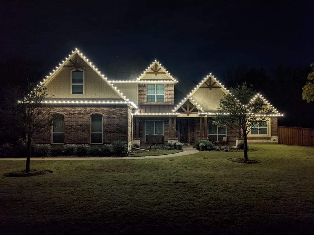 Home outlined with Christmas lights